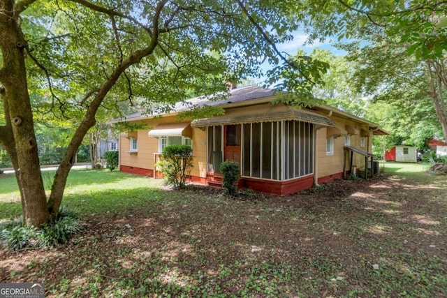 rear view of property featuring a yard