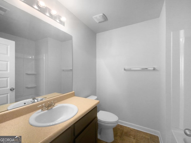 bathroom with vanity, a shower, and toilet