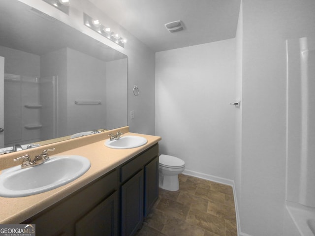 bathroom featuring vanity, walk in shower, and toilet