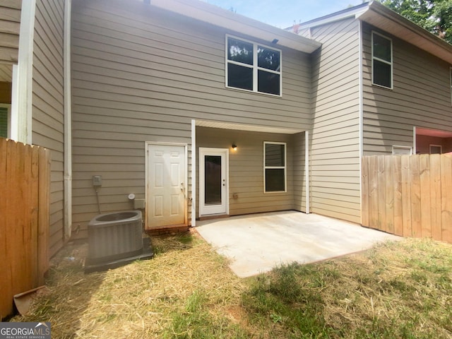 rear view of house featuring central AC unit and a patio