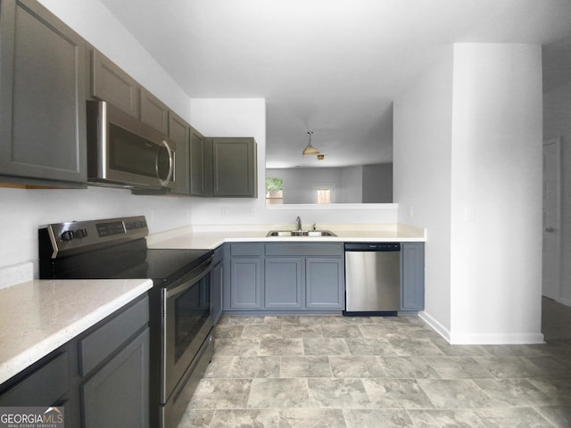 kitchen with sink, gray cabinets, and appliances with stainless steel finishes