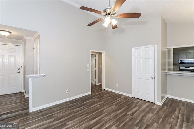 unfurnished living room featuring dark wood-type flooring, ceiling fan, and high vaulted ceiling