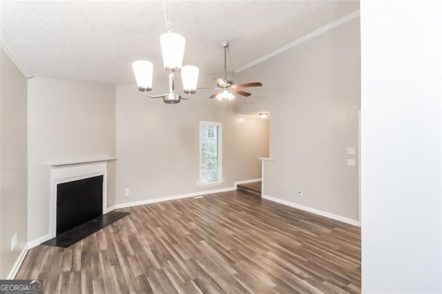 unfurnished living room with dark wood-type flooring, vaulted ceiling, a textured ceiling, ornamental molding, and a notable chandelier