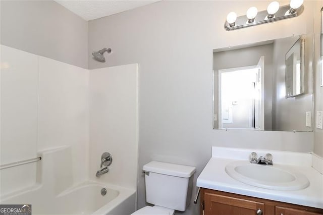 full bathroom featuring vanity, shower / washtub combination, and toilet