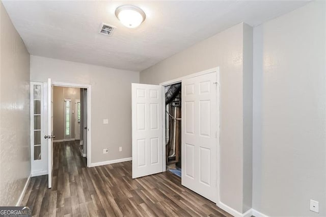 unfurnished bedroom featuring dark hardwood / wood-style flooring