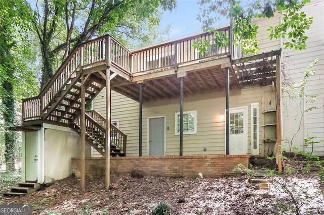 rear view of house featuring a deck