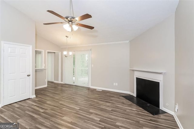 unfurnished living room with ceiling fan with notable chandelier, vaulted ceiling, and dark hardwood / wood-style floors