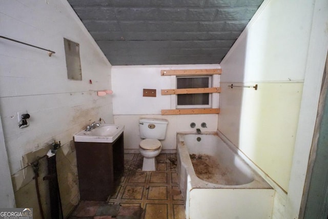 bathroom with a tub, toilet, tile patterned floors, and vanity