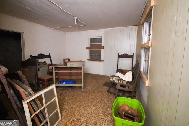 bedroom featuring tile patterned floors and wooden walls