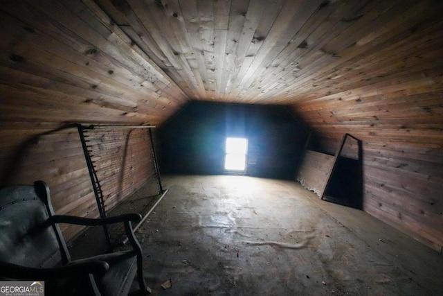 additional living space with wooden walls, vaulted ceiling, and wooden ceiling