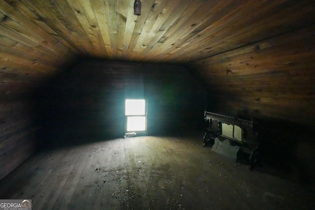 bonus room with vaulted ceiling, wooden ceiling, and a wood stove