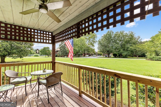 deck with ceiling fan and a yard