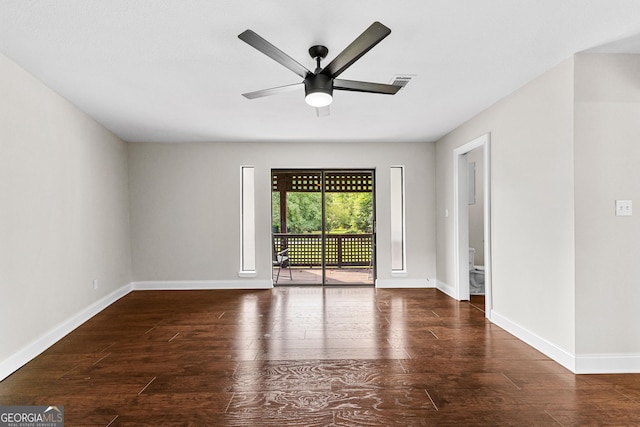 empty room with dark hardwood / wood-style floors and ceiling fan