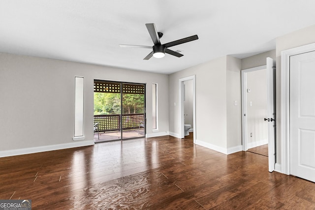 empty room featuring dark wood-type flooring and ceiling fan