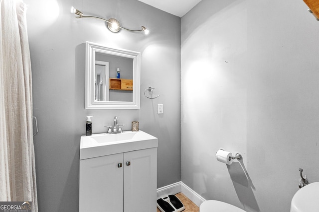 bathroom featuring vanity and toilet