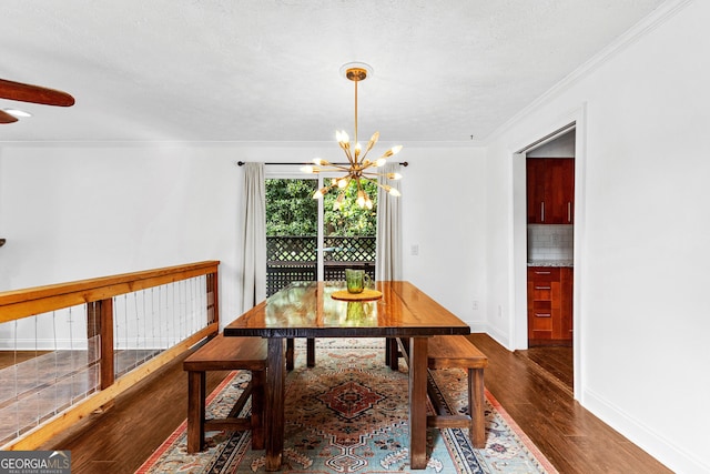 dining room with dark hardwood / wood-style flooring, ornamental molding, and a chandelier