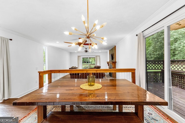 dining room with an inviting chandelier, crown molding, and hardwood / wood-style flooring