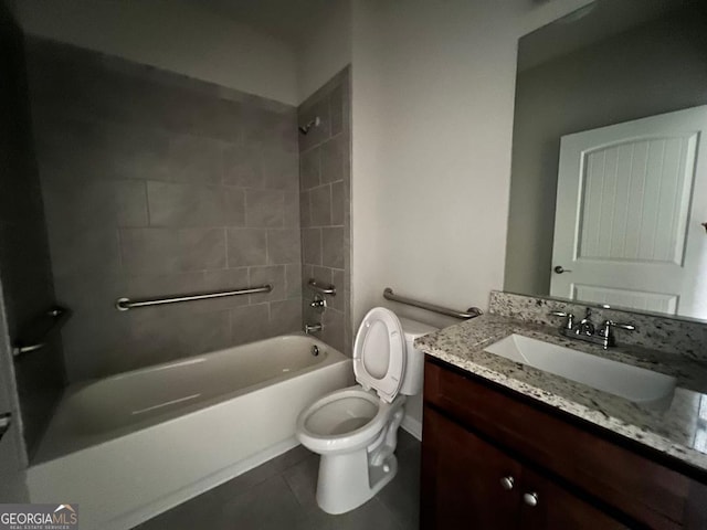 full bathroom featuring tiled shower / bath combo, tile patterned floors, toilet, and vanity