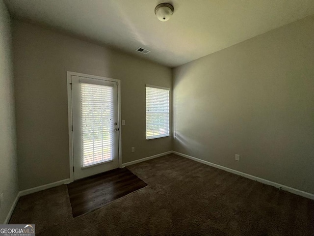 foyer with dark carpet