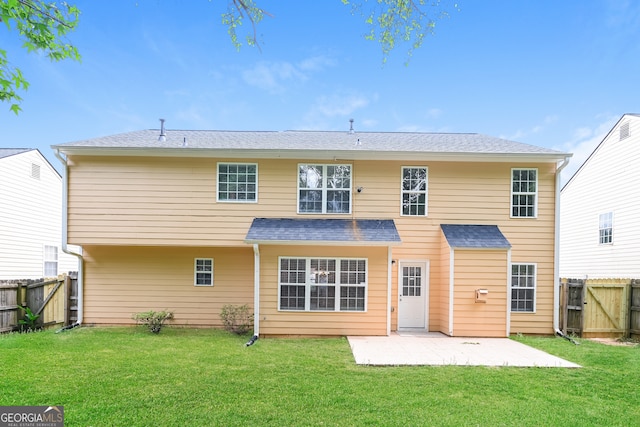 back of house with a patio area and a yard