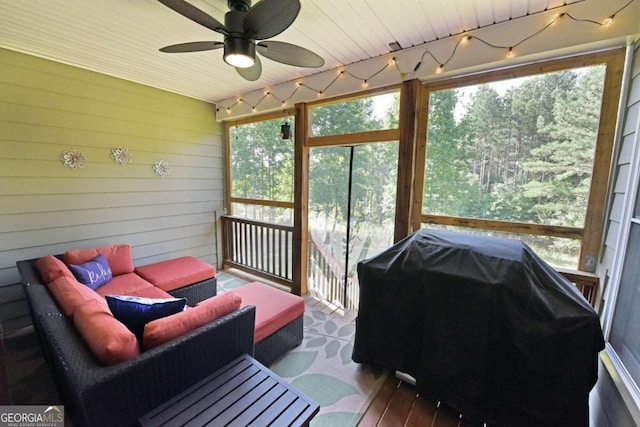 sunroom featuring track lighting and ceiling fan