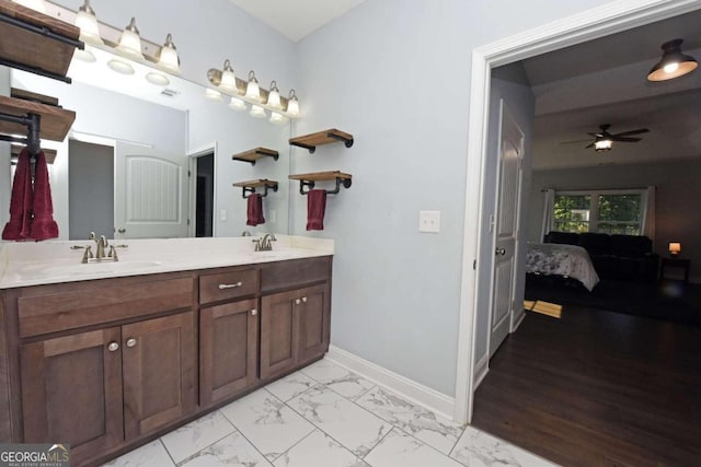 bathroom featuring hardwood / wood-style floors, ceiling fan, and dual bowl vanity