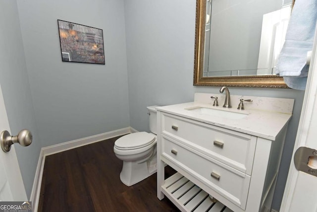 bathroom with vanity, toilet, and hardwood / wood-style floors