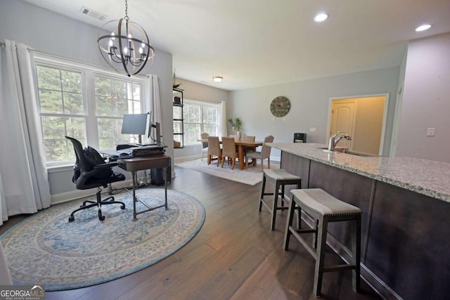 office space with sink, a wealth of natural light, a chandelier, and dark wood-type flooring