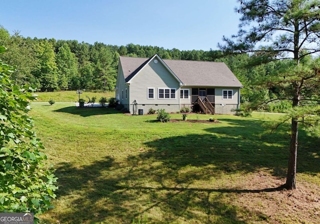 back of house with a lawn