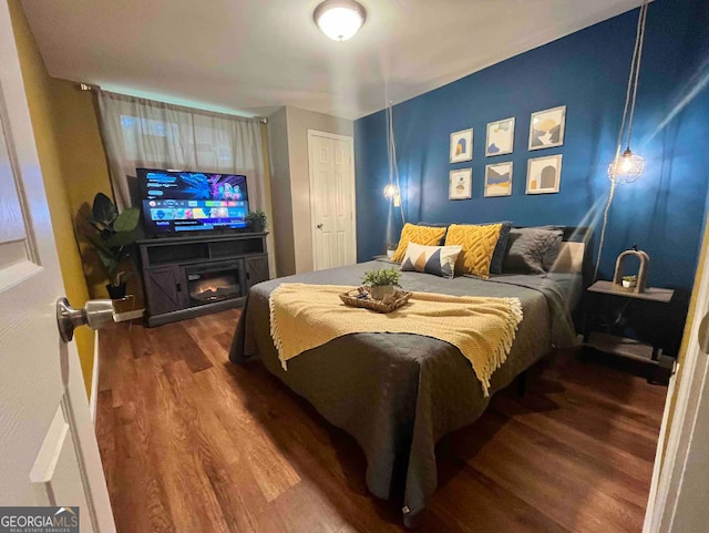 bedroom with dark wood-type flooring