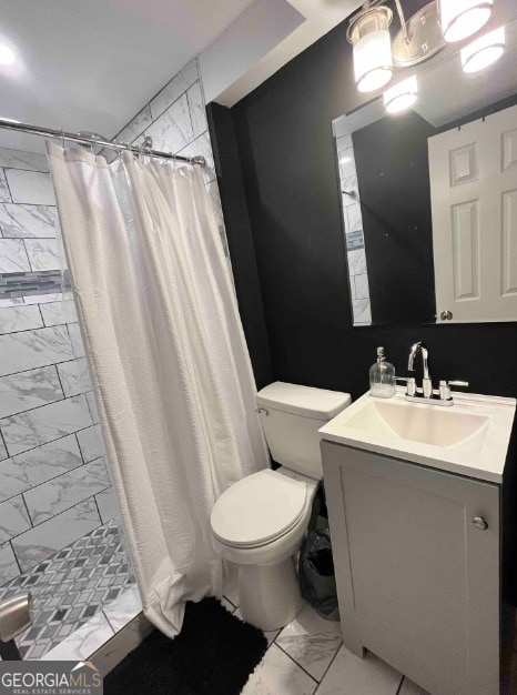 bathroom featuring curtained shower, tile patterned floors, toilet, and vanity