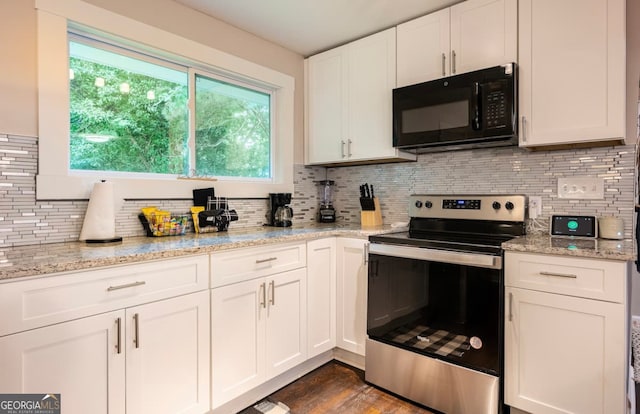 kitchen featuring stainless steel electric range oven, dark hardwood / wood-style floors, and backsplash