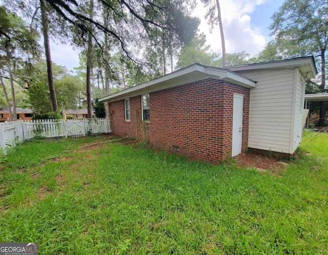 1217 Whispering Pines Rd, Albany, GA 31707 - view of side of home with a yard