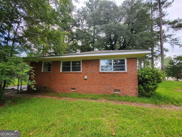 1217 Whispering Pines Rd, Albany, GA 31707 - view of side of property with a lawn