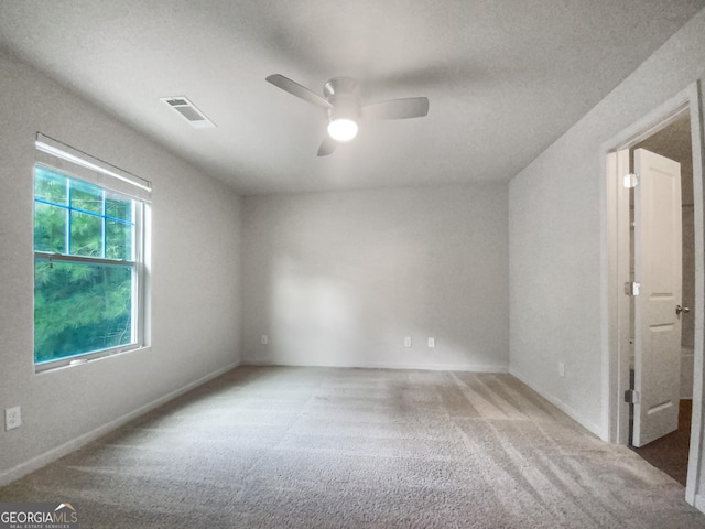 empty room featuring carpet floors and ceiling fan