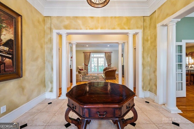 hall featuring ornate columns, crown molding, and light tile patterned floors