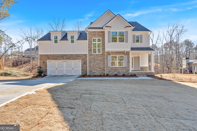 view of front of property featuring a garage, a front lawn, and central air condition unit