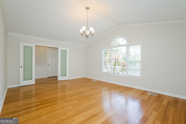 interior space with lofted ceiling, light hardwood / wood-style floors, crown molding, and a chandelier