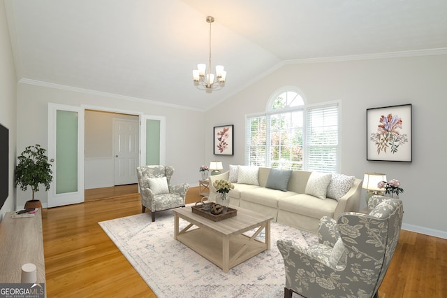 living room with ornamental molding, a notable chandelier, light hardwood / wood-style flooring, and vaulted ceiling