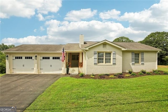 view of front of home featuring a garage and a front lawn