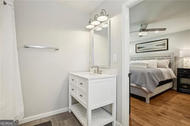 interior space with hardwood / wood-style flooring, vanity, and ceiling fan