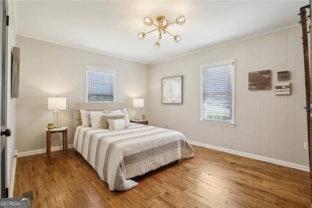 bedroom featuring ornamental molding and hardwood / wood-style flooring