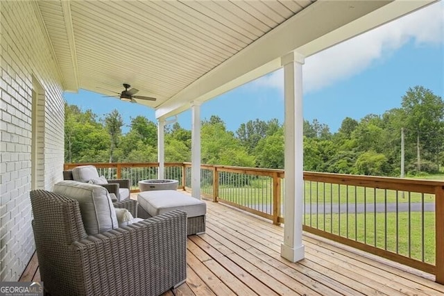 deck with ceiling fan and a lawn