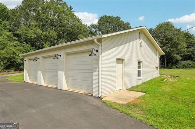 garage featuring a lawn