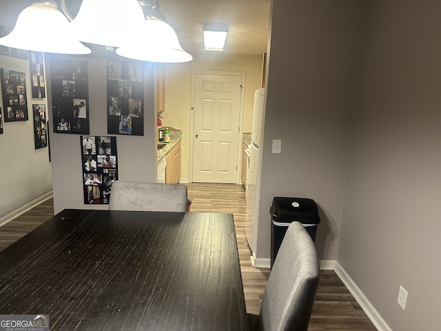 hallway with dark hardwood / wood-style flooring