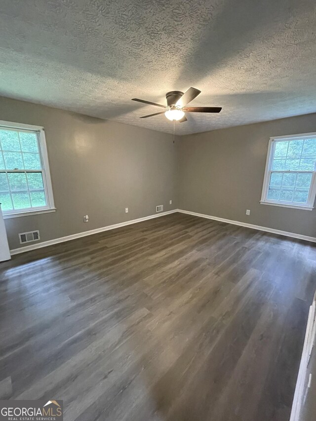 spare room featuring a textured ceiling, ceiling fan, and hardwood / wood-style floors