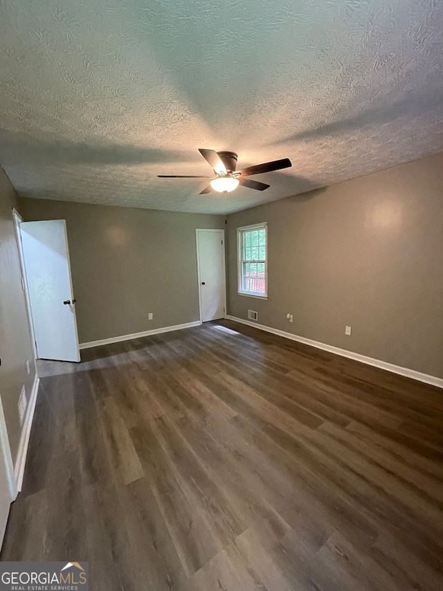 spare room featuring wood-type flooring, a textured ceiling, and ceiling fan