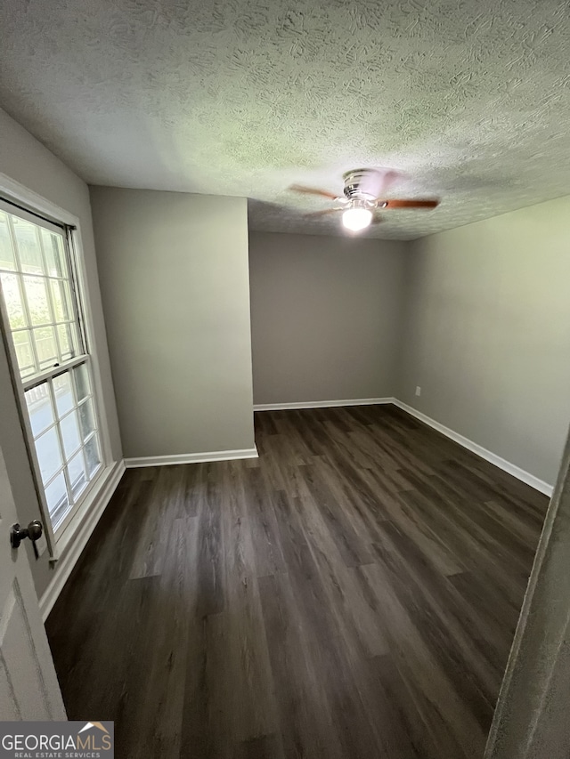 unfurnished room featuring a textured ceiling, ceiling fan, and wood-type flooring