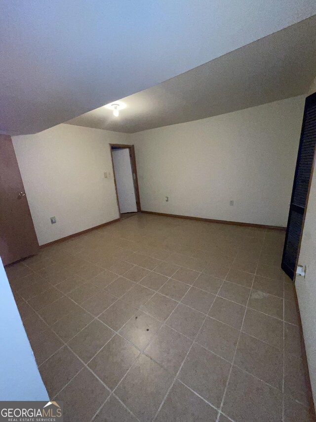 bonus room with tile patterned floors