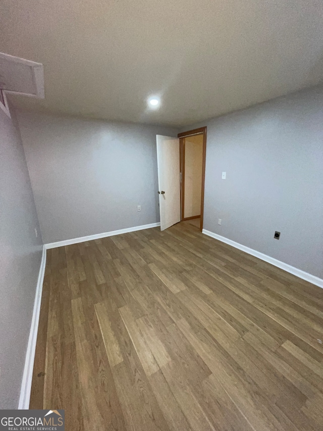 unfurnished room featuring a textured ceiling and hardwood / wood-style floors